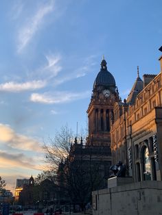 a large building with a clock on it's face in front of a blue sky