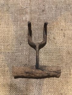 a piece of wood that has been made into a hook on top of burlock