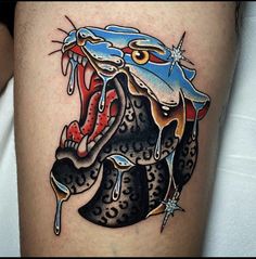 an artistic tattoo design on the thigh of a woman's leg with a bull