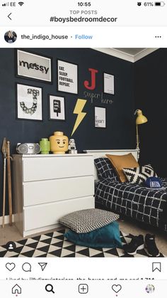 a bedroom with black and white decor on the walls, an image of a lightning bolt is above the bed