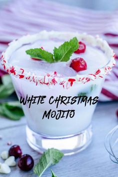 a white christmas mojit is garnished with cherries