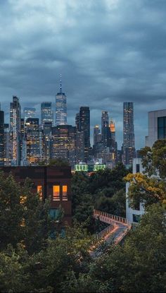 the city skyline is lit up at night, with skyscrapers visible in the distance