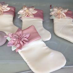 three christmas stockings decorated with flowers and ribbons