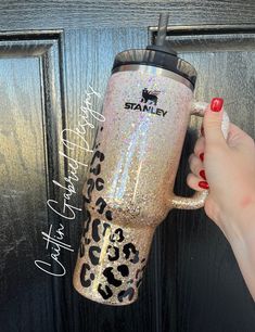 a woman's hand is holding a starbucks cup in front of a door