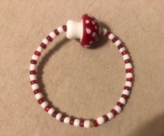 Cute red and white beaded bracelet with a mushroom charm. 8 inches across Mushroom Bracelet, White Beaded Bracelet, Mushroom Jewelry, Beaded Bracelet, 20 Cm, Red And White, Jewelry Bracelets, Stuffed Mushrooms, Etsy Accessories