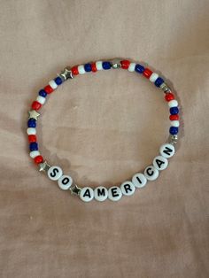 A hand-crafted glass bead friendship bracelet highlighting Olivia Rodrigo's song "So American"! A simple and cute way to show off your favorite song or a great concert accessory!  This bracelet is made with Czech glass beads, plastic letter beads, plastic spacer beads, and is on an elastic thread measured at about 10 inches in length for a relaxed/loose fit. If you would like the bracelet you order to be smaller or larger, please leave the requested size in inches in the personalization box!  Al Song Lyric Bracelet, Olivia Rodrigo Friendship Bracelet, Olivia Rodrigo Bracelets, Olivia Rodrigo Bracelet Ideas, Olivia Rodrigo Bracelet, Concert Bracelets, Bead Friendship Bracelet, Kawaii Bracelet, Music Bracelet