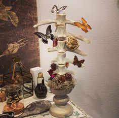 there is a vase with butterflies on it and other items in front of the wall