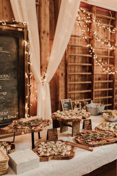 a table topped with pizzas and other food