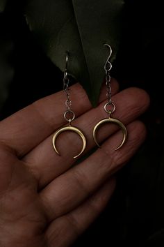 Elegant with a touch of rustic. Solid cast brass golden moons dangle from solid sterling silver chain and ear hooks. These handcrafted brass moon earrings have been inspired into creation by my cyclical obsession with the moon and all her phases. The crescent moon facing down can be symbolic for the north node of our birth chart, which points the way our soul is traveling and what we came here to learn. I like to think of these earrings as little dangling moons that carry the energy forward of w Moon Drop Earrings, Moon Phase Brass Earrings For Festival, Festival Moon Phase Brass Earrings, Brass Moon Charm Earrings For Festival, Mystical Moon Shaped Brass Earrings, Mystical Moon-shaped Brass Earrings, Brass Earrings With Moon Charm For Festivals, Brass Festival Earrings With Moon Charm, Handmade Moon-shaped Spiritual Earrings