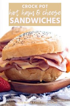 crock pot hot ham and cheese sandwiches on a plate with strawberries in the background