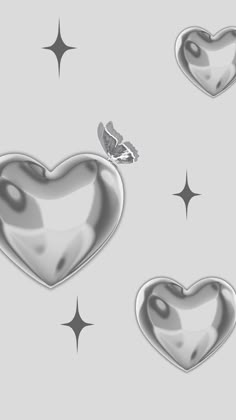 three heart shaped objects on a gray background