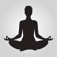 the silhouette of a person sitting in a lotus position