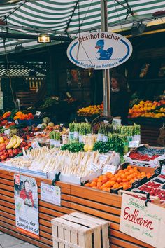 an outdoor market with fruits and vegetables on display