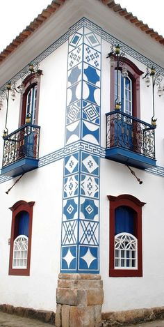 a white and blue building with two balconies