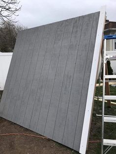 a house that has been built into the ground and is being worked on by a ladder