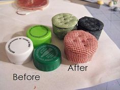 four different colored containers sitting on top of a white tablecloth next to each other