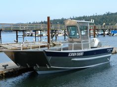 a small boat is docked at the dock