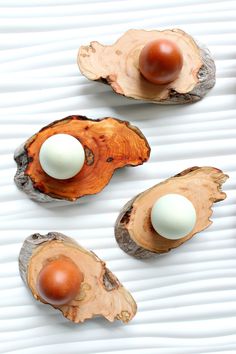 three pieces of wood with eggs in them sitting on top of each other next to another piece of wood