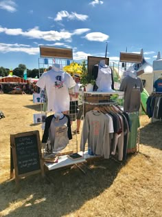 an outdoor clothing stand with t - shirts on display