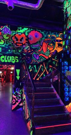 the stairs are lit up with colorful lights and graffiti on them in this dark room