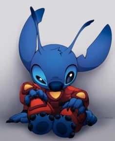 a blue cartoon character sitting on the ground