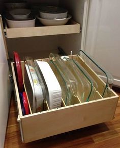 an open drawer with dishes in it