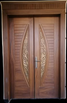 two wooden doors with intricate carvings on them, one is open and the other has a sidelight