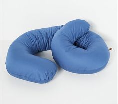 two blue pillows sitting on top of each other