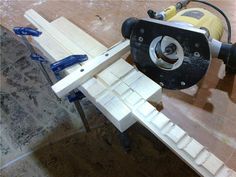 a machine that is sitting on top of a piece of wood in the process of being made