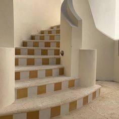 there is a set of stairs with yellow and white tiles on the bottom one side