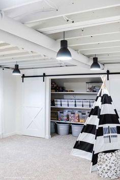 a black and white striped teepee is hanging from the ceiling