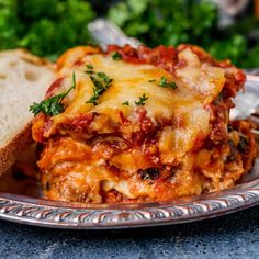 a slice of bread on a plate with lasagna