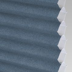 a close up view of some blue and white blinds