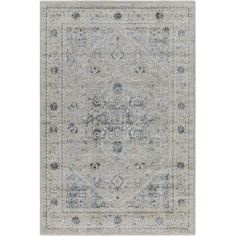 an area rug with blue and grey colors on the floor, including a large medallion design