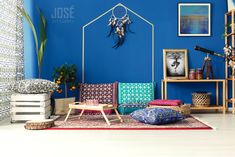 a living room with blue walls and colorful furniture