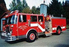 a red fire truck parked in front of a house