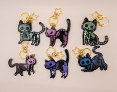 six key chains with different colored cats on them