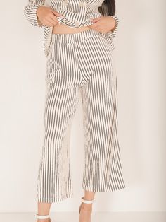 The Holland Pinstripe Pants are the perfect combination of comfort and style! Their pinstriped design adds a touch of sophistication, while the matching blazer offers versatility. The flowy fit ensures a flattering fit for any body type. Elevate your business casual wardrobe with these must-have pants! Details Thick Stretchy Waistband Pinstriped Wide Leg Cropped Length Size recs: 2-4 Small, 6-8 Medium, 10 Large Provides stretch Straight Pants With Vertical Stripes For Spring, Spring Straight Pants With Vertical Stripes, Spring Wide-leg Pants With Vertical Stripes, Spring Wide Leg Pants With Vertical Stripes, Ankle-length, Wide Leg Ankle-length Pants With Vertical Stripes For Spring, Spring Ankle-length Wide Leg Pants With Vertical Stripes, Chic Pinstripe Trousers, Pinstripe Wide-leg Bottoms With Relaxed Fit, Straight Pants With Contrast Stripes For Spring