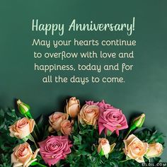 some pink roses and green leaves are in front of a blackboard with the words happy anniversary