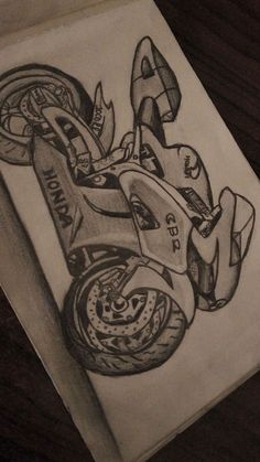 a pencil drawing of a motorcycle on a piece of paper