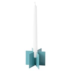 a candle holder with a single white candle in the center and two square sections on each side