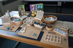 the table is set up with various items for making jewelry and cards on it,