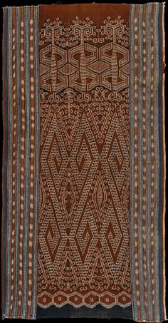 an old brown and blue cloth with geometric designs on it's sides, in the middle