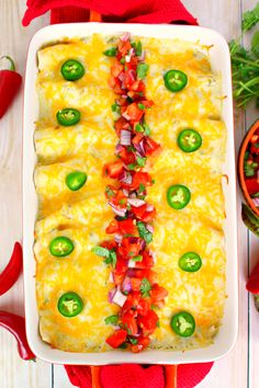 an enchilada casserole with red peppers and jalapenos