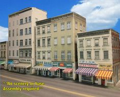 there are many buildings on the street corner with awnings and striped awnings