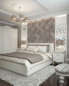 a large white bed sitting under a chandelier in a bedroom next to a chair