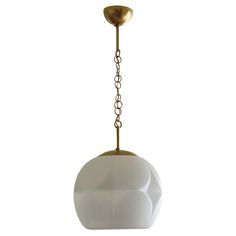 a white and gold pendant light hanging from a ceiling