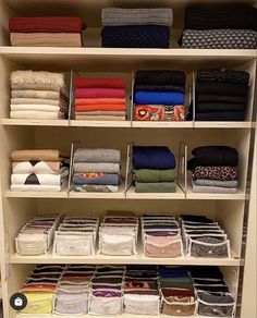 an organized closet filled with folded clothes