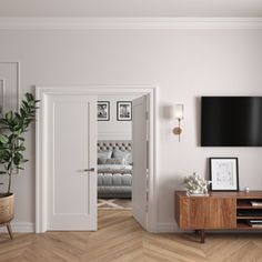 a living room with white walls and wood floors