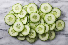 cucumber slices are arranged on a marble surface